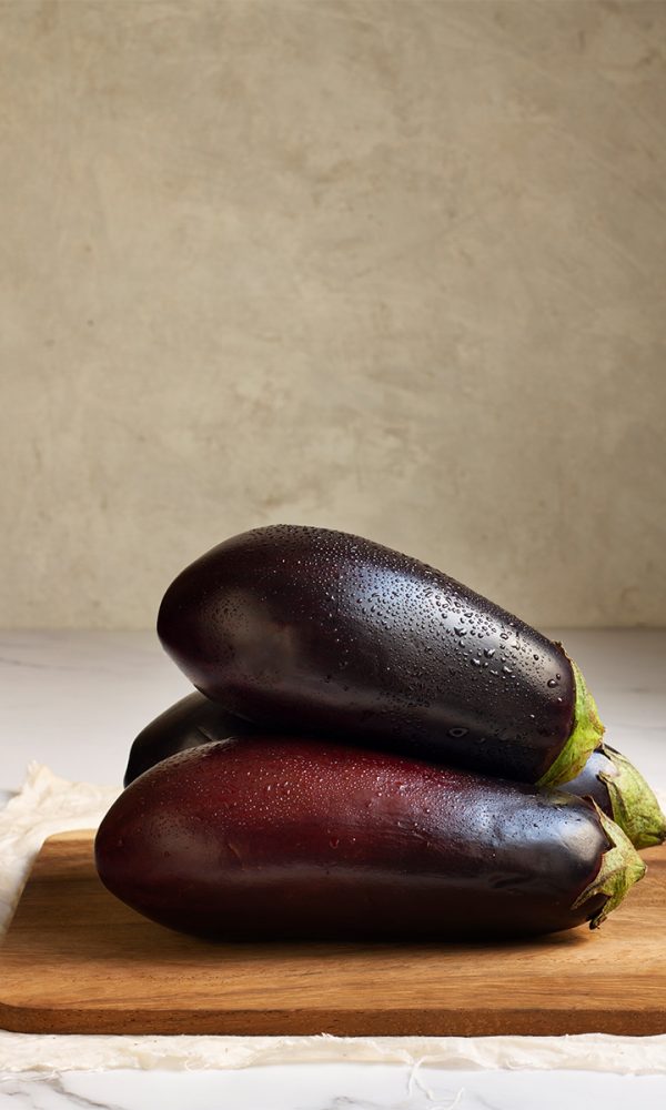 Fresh raw eggplants arrangement 600x1000