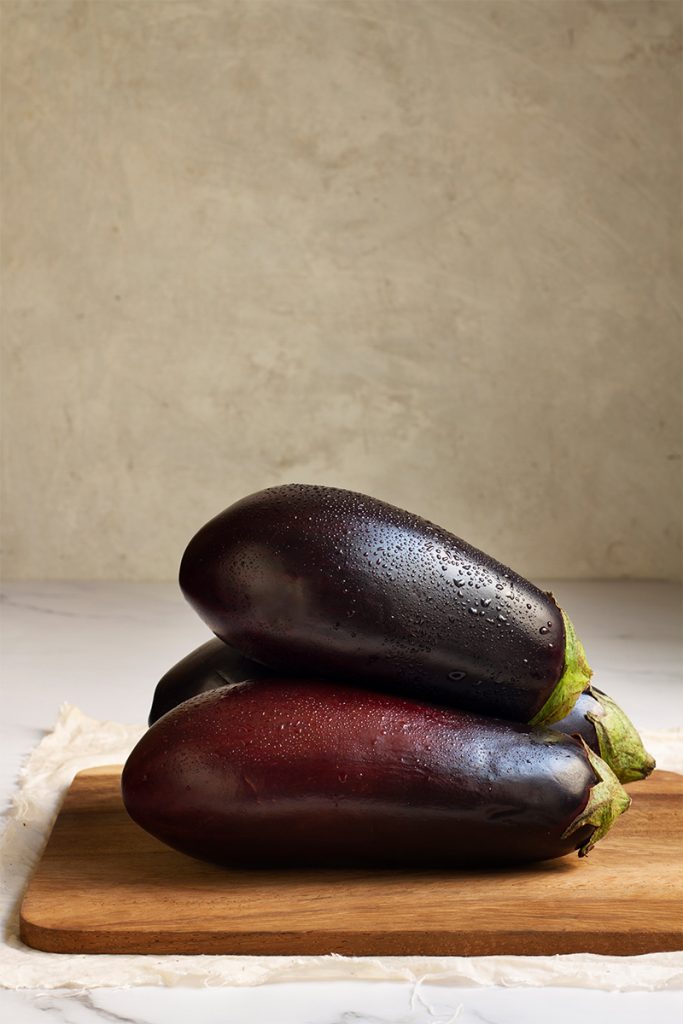 Fresh raw eggplants arrangement 683x1024