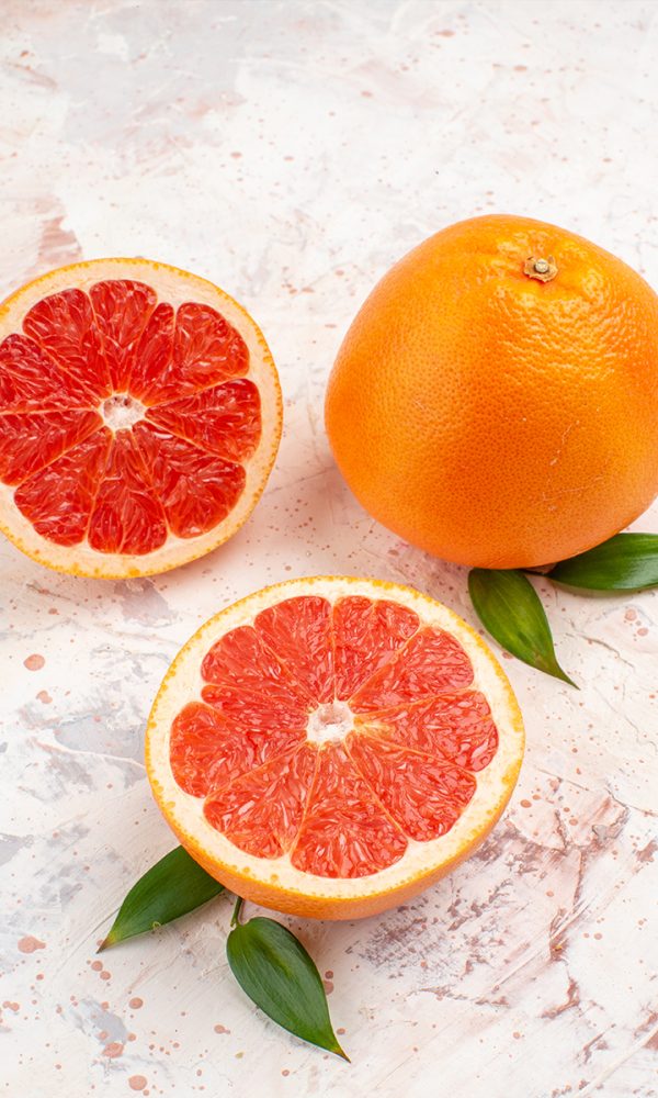 Front view cut grapefruits fresh grapefruit nude background 600x1000