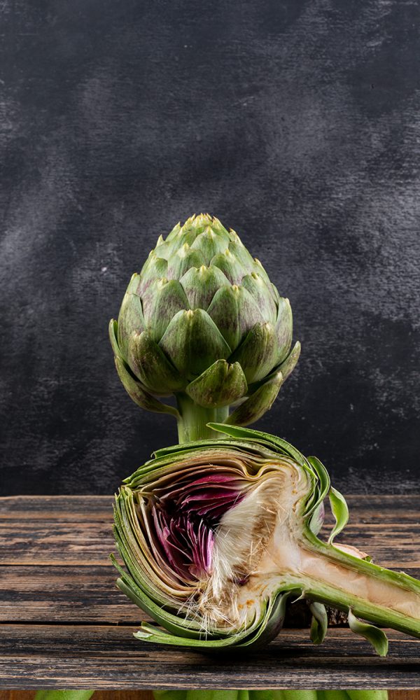 Side view artichoke slice dark wooden black background horizontal space text 600x1000